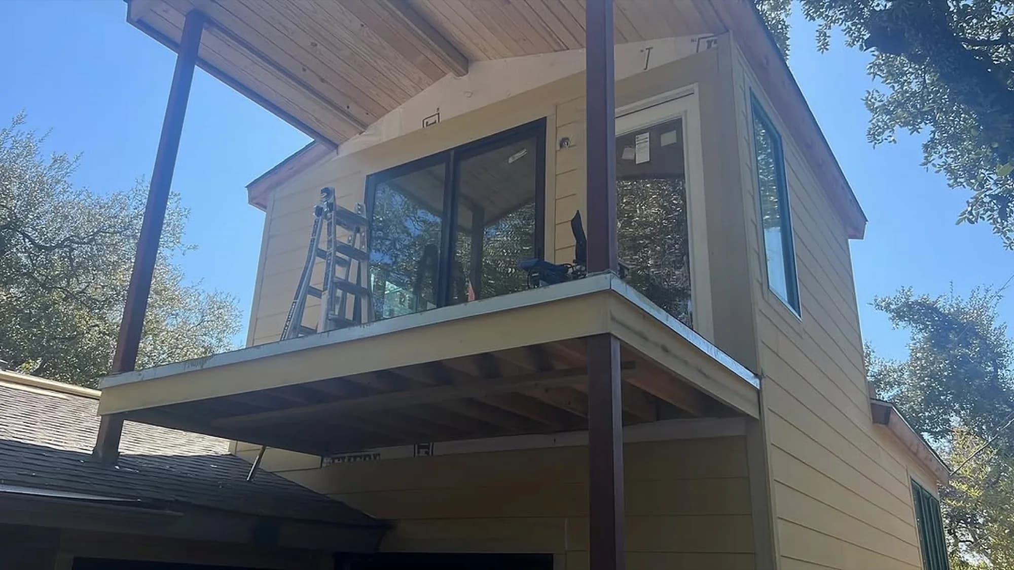 ADU addition with siding and balcony openings