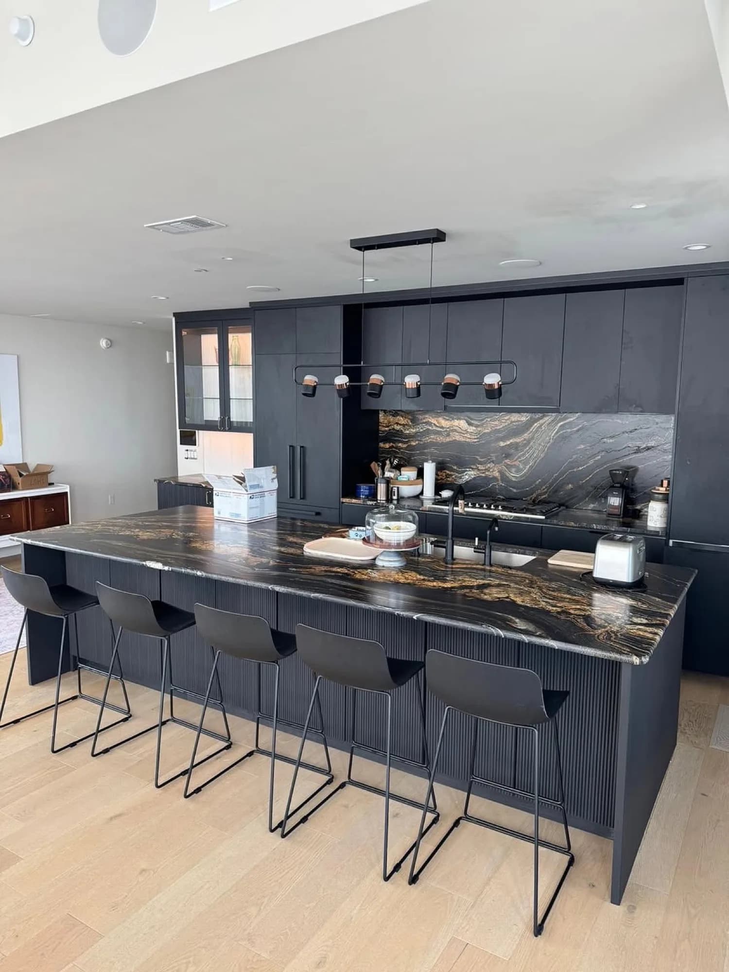 Black fluted island with dramatic marble